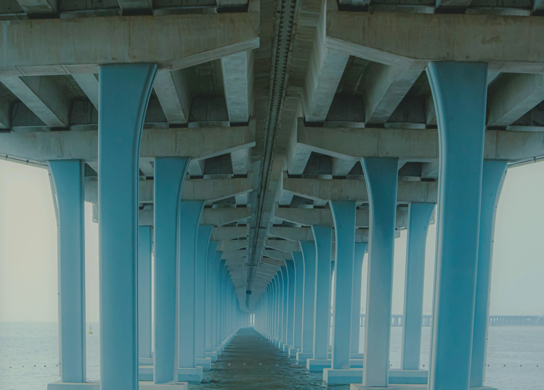 a couple of large pillars under a bridge