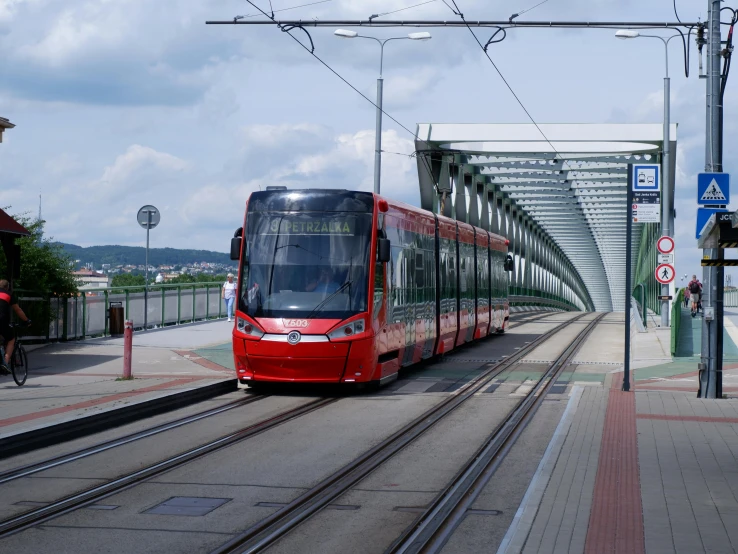 a red trolley train in a subway station