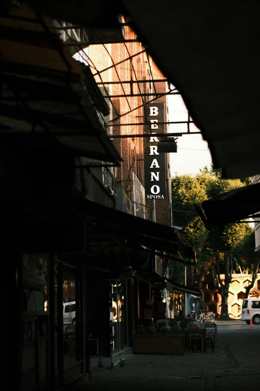 a bus station with a street sign above it