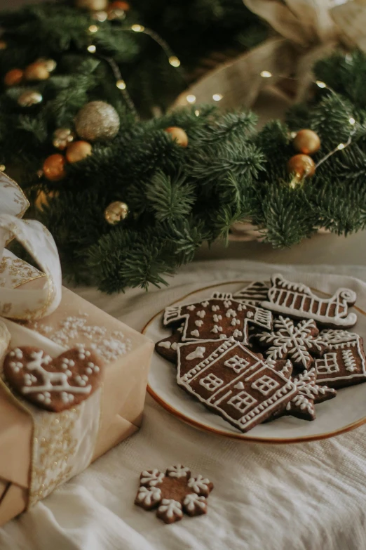 a table set for christmas has several holiday cookies and presents