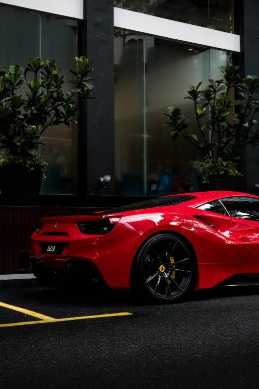 the large red sports car is parked in a spot