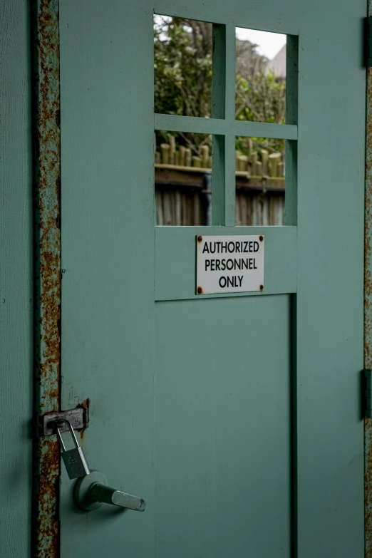 the door to an old  cell that has a sign stating there is a designated personnel only