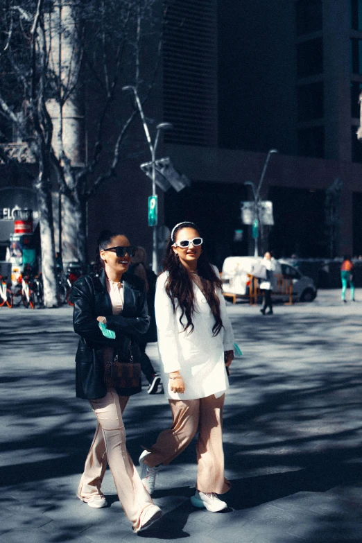 two women walking down a street in the dark