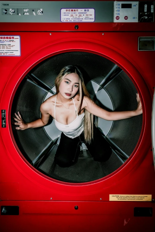 a woman in a washing machine is posing for the camera