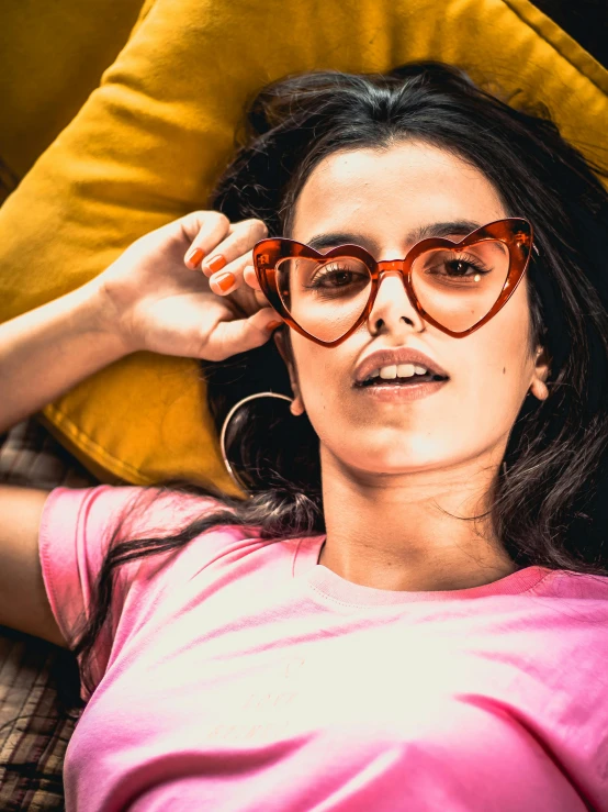 an image of a girl wearing a pink shirt and a pair of glasses