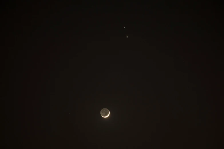 the moon in the distance is shown against a dark sky