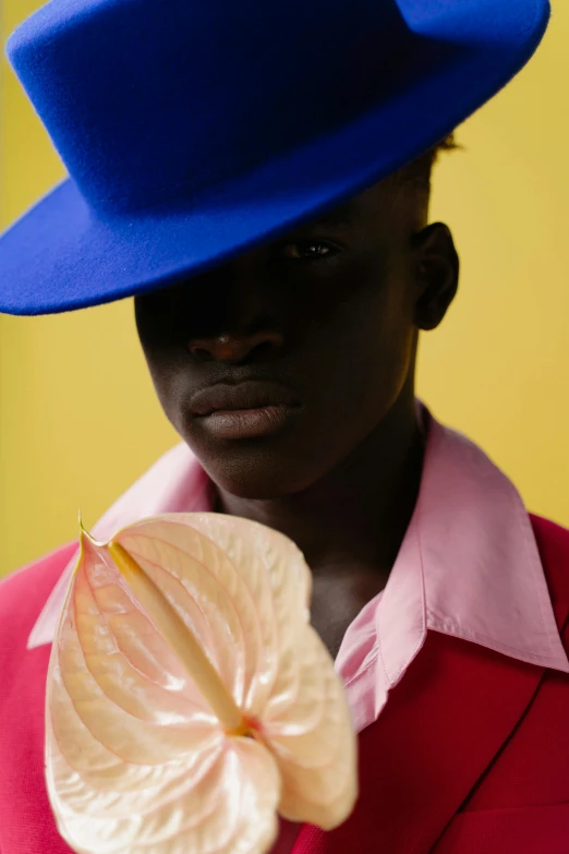 the man is holding a flower in his hand