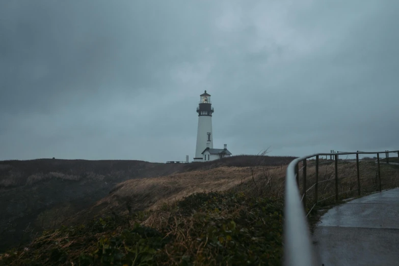 a pathway to a lighthouse on a stormy day