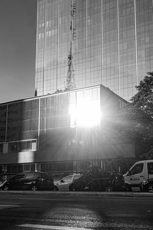 a black and white image of parking lot with a building