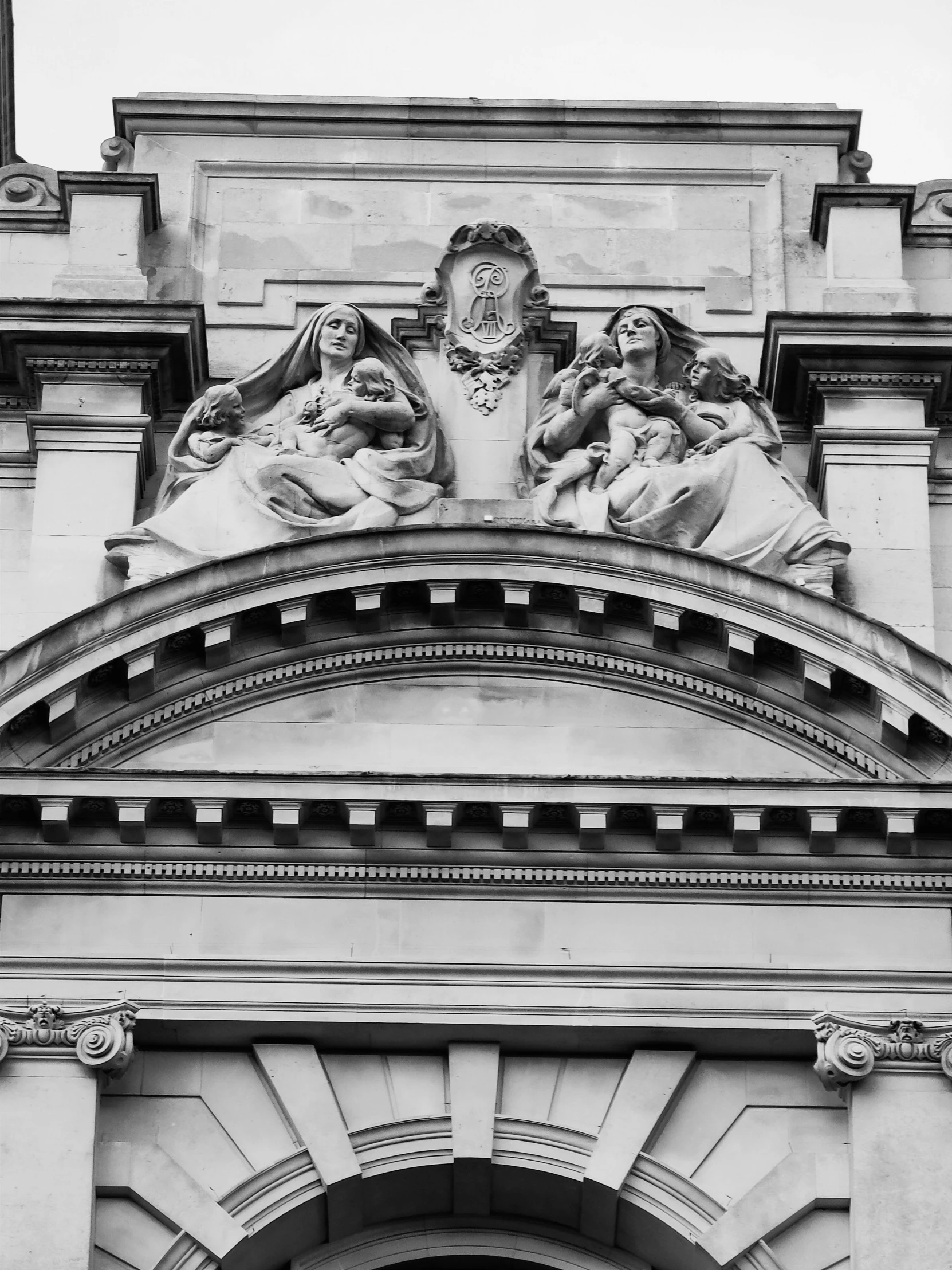 an architectural building with a very large sculpture on top