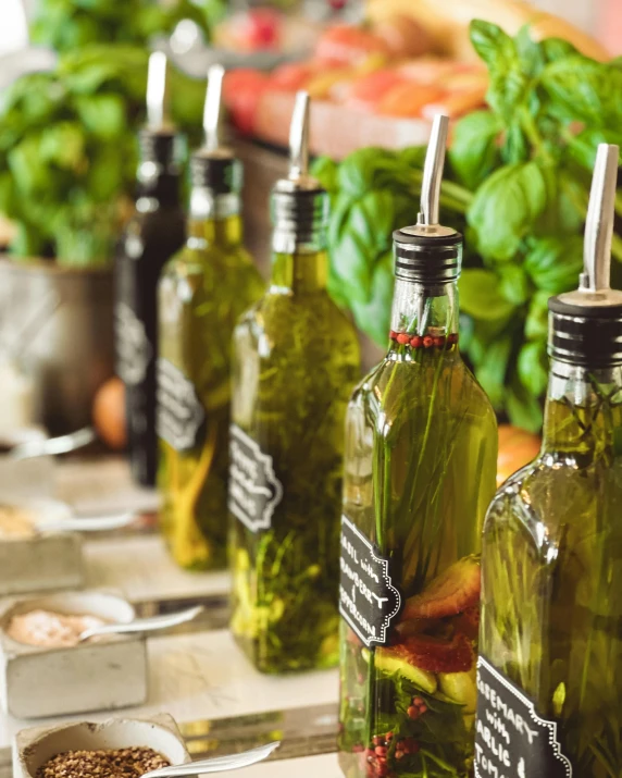 three bottles of pickles on a table