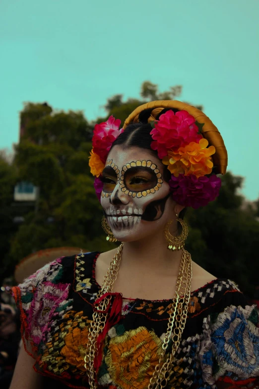 a woman with painted make up is wearing an elaborate head piece