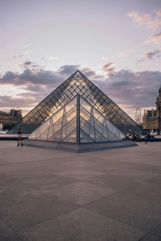 an ornate glass pyramid in the middle of a square