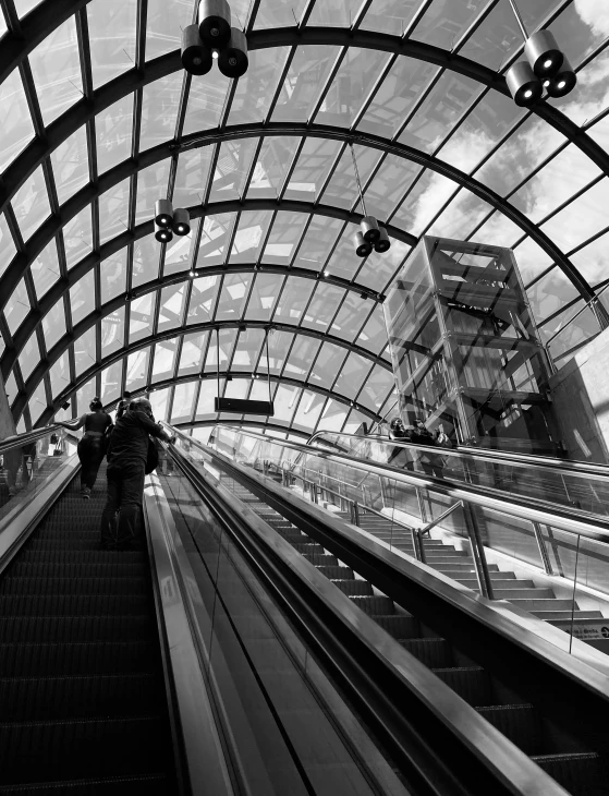 an escalator leads up to the platform at a train station