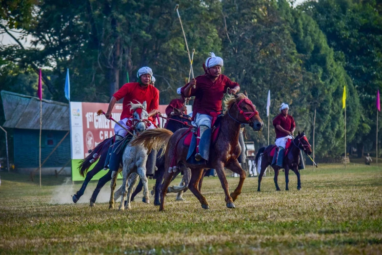 polo players on their horses with flags at the start