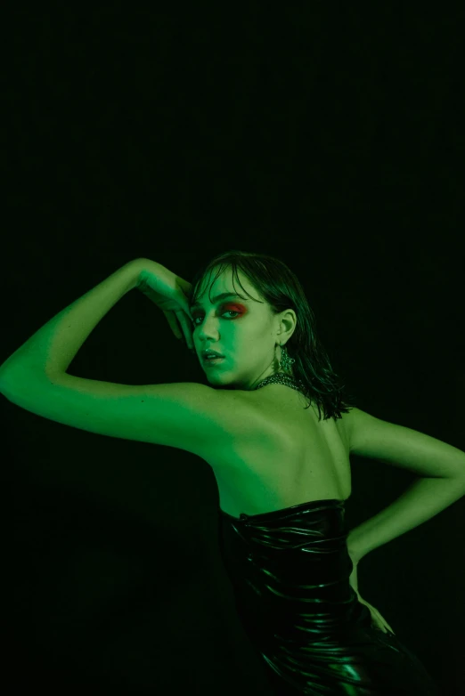 a woman with green light on her face and shoulders