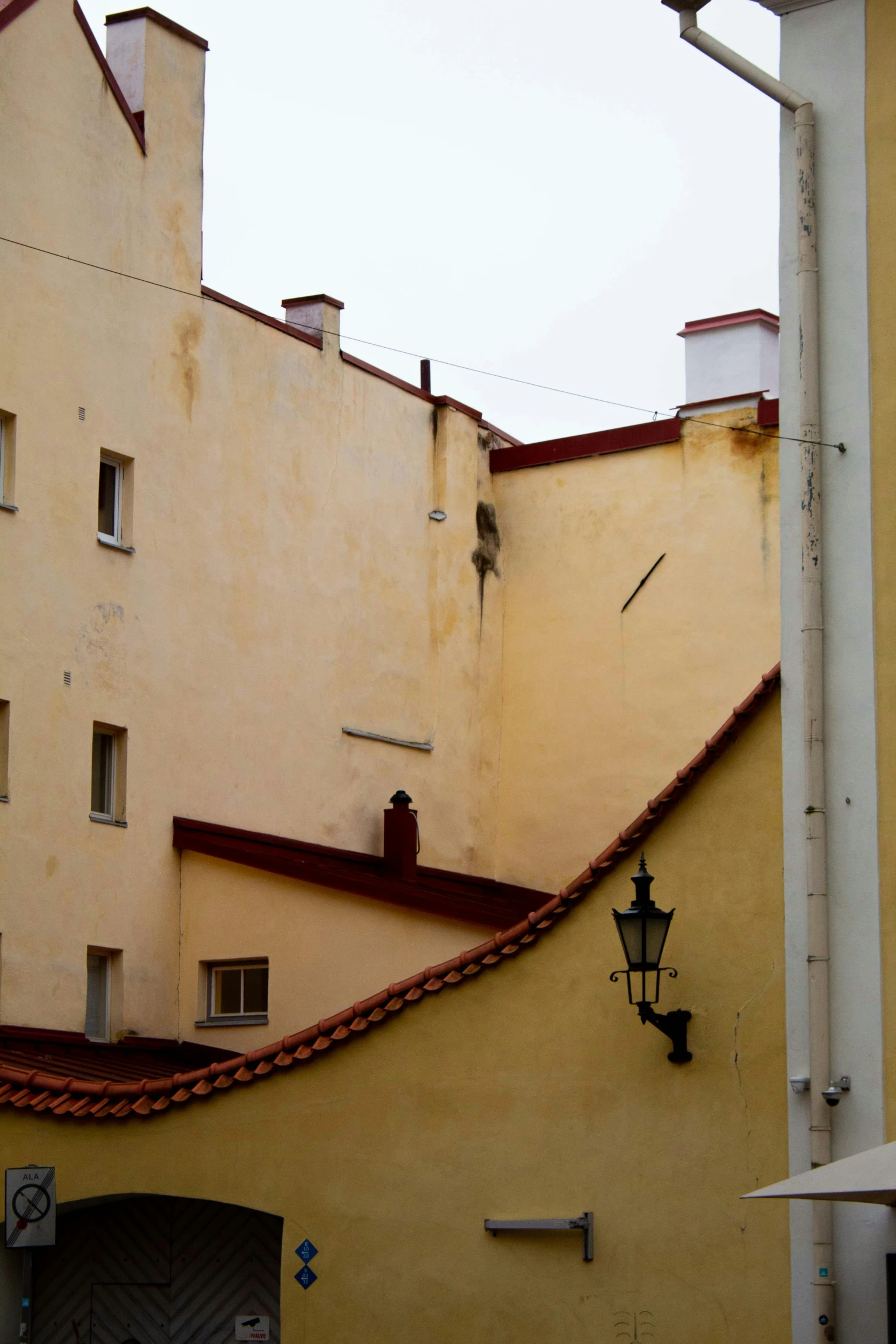 a clock mounted on a wall next to buildings