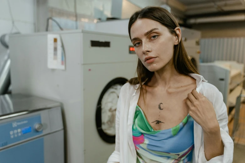 woman in front of a dryer looking at her dress