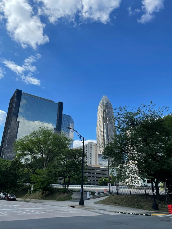 a big building is in the distance and a tall tree