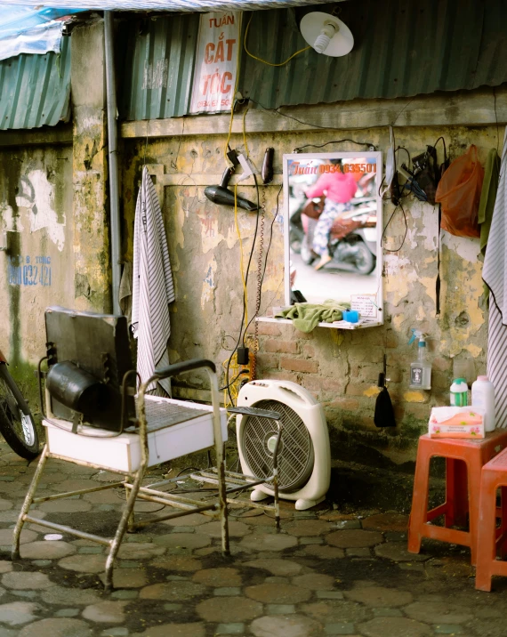 there is a old fan sitting outside a building