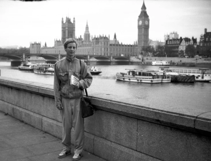 a man is standing on a bridge and is holding soing