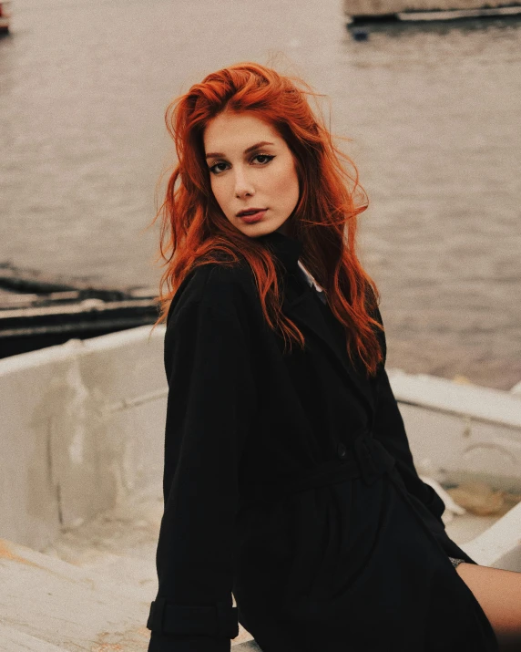 a red headed woman standing on top of a boat