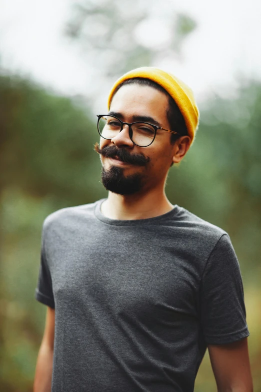 a man wearing glasses and a yellow hat