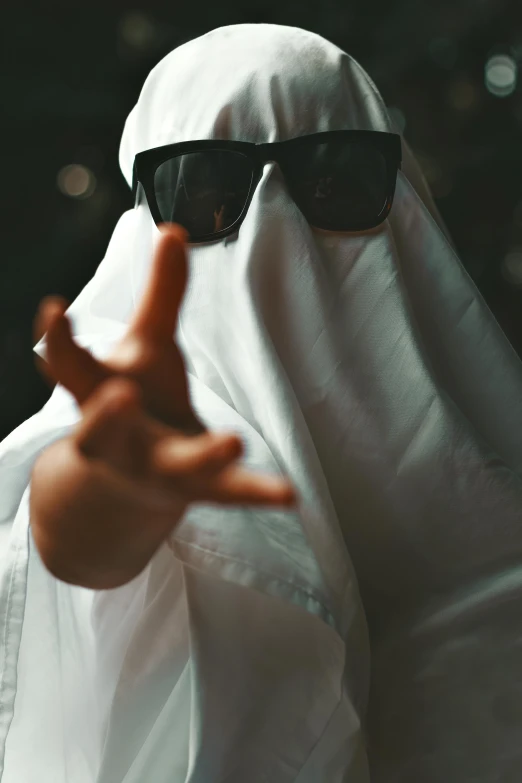 a person wearing a white outfit is making a peace sign