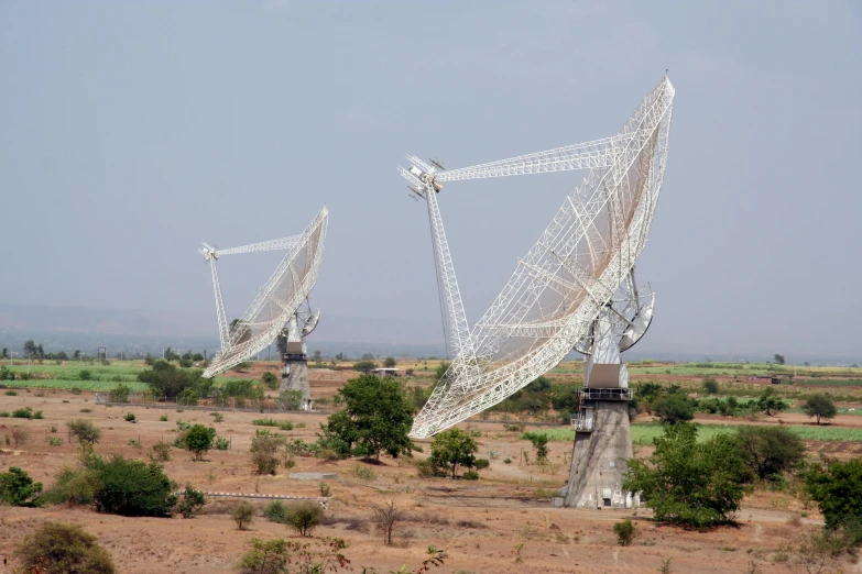 a radio antenna array of white nettings and metal poles