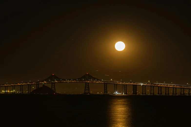 a large light house with a full moon setting