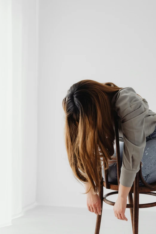 a woman is on her back in a chair