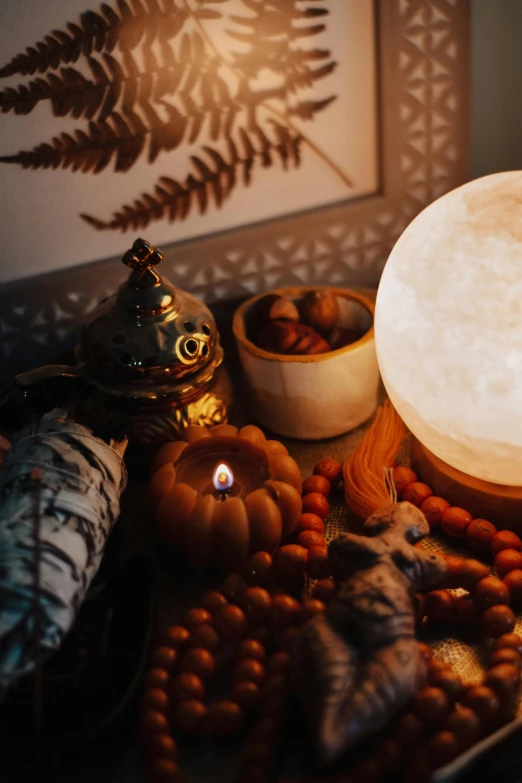 candles and rocks on the table next to a decorative lantern