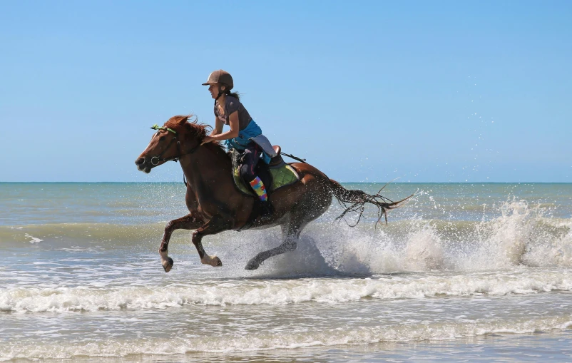 a person on a horse is riding through the water