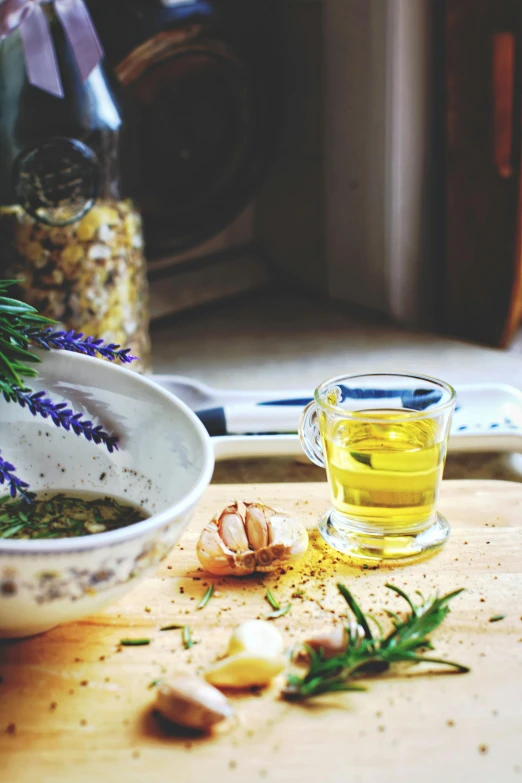 garlic and garlic oil on a  board next to a bowl of garlic