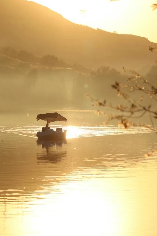 a couple of boats floating on top of a lake