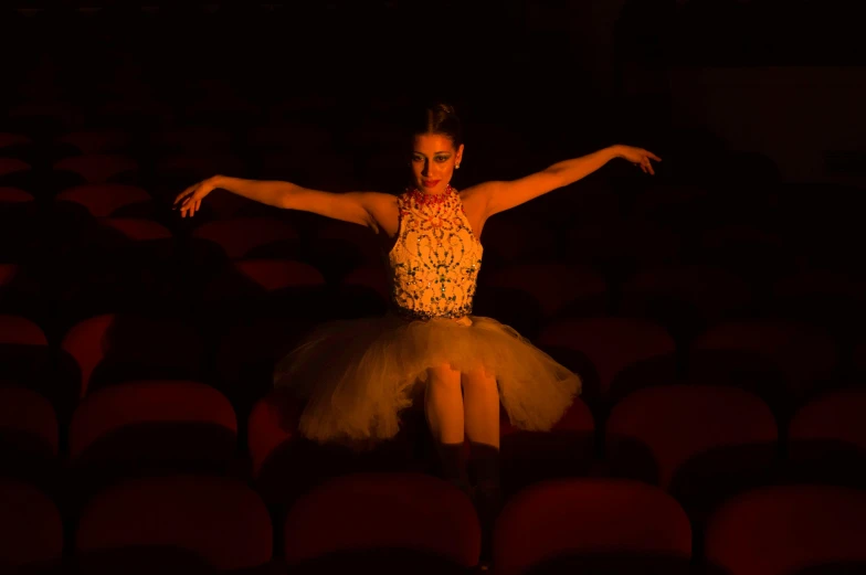 a woman is sitting in a dimly lit area