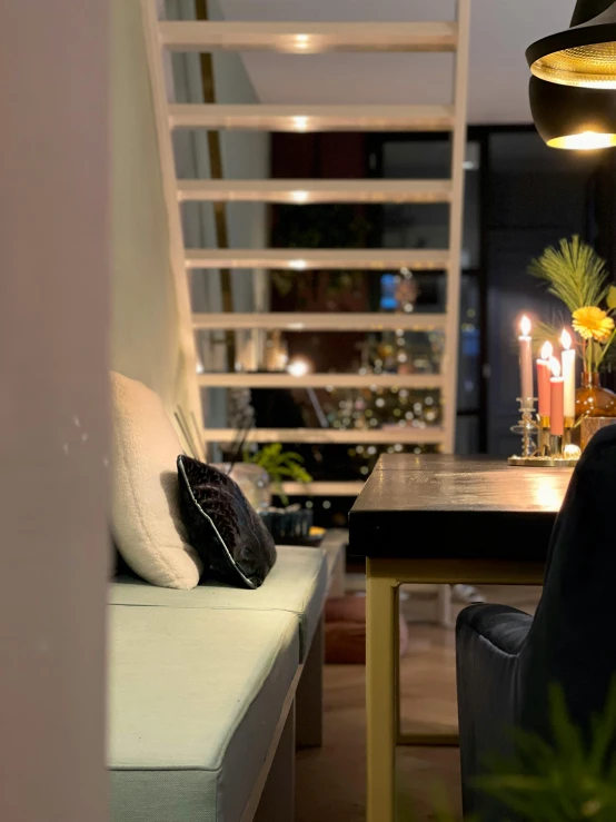 a table with a black cushion and a set of candles