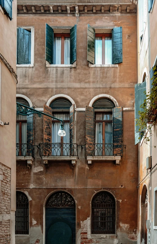 a big building with green doors and red brick windows