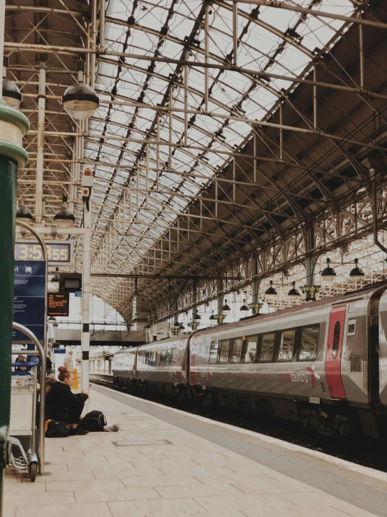 the train is stopped at the station near many people