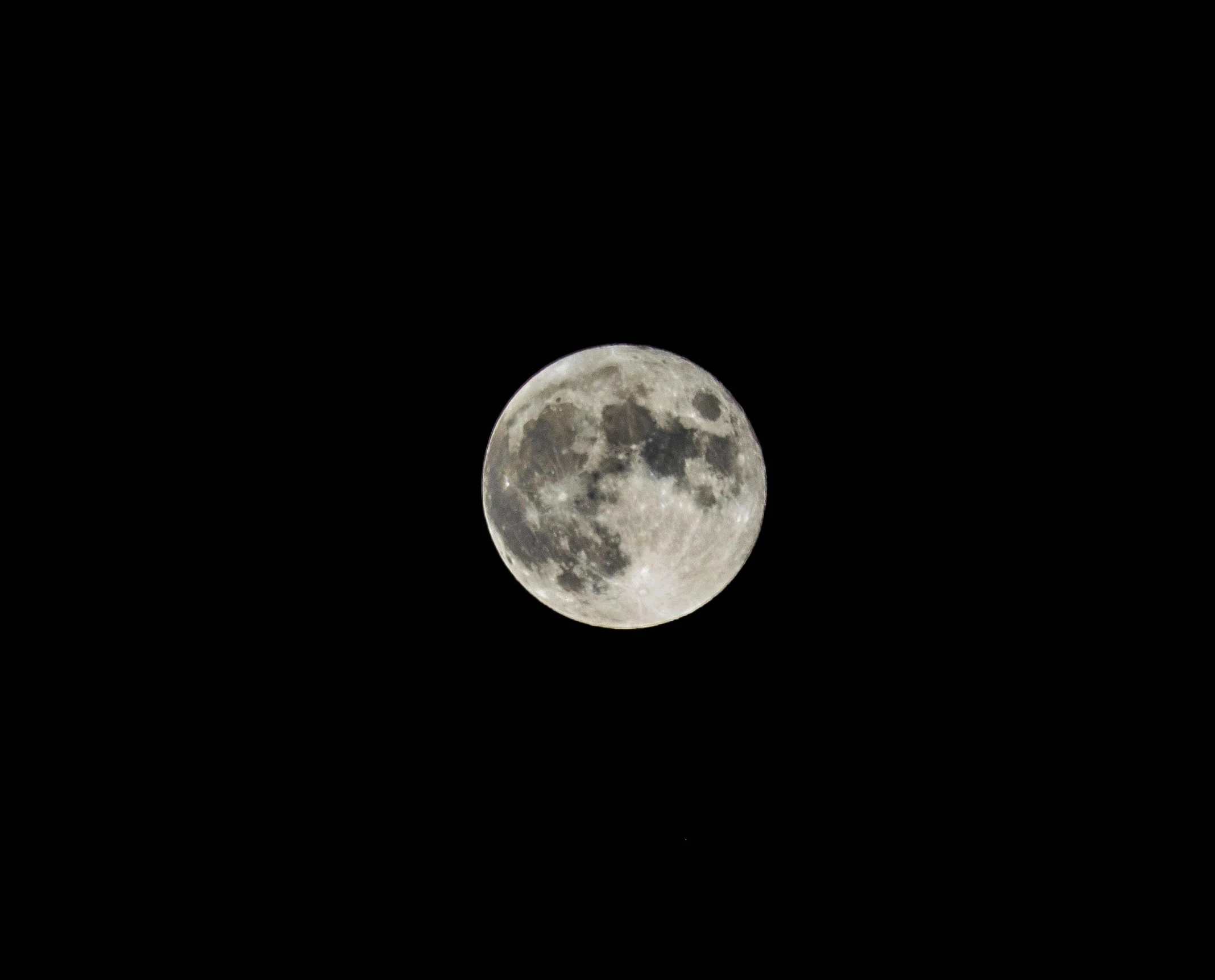 a large full moon on a black night sky