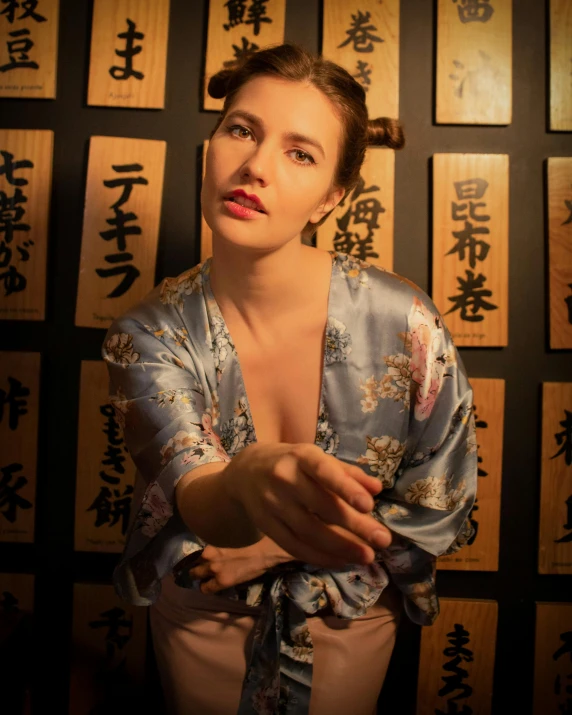 a woman in an oriental kimono is posed