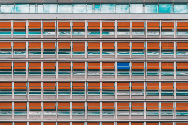 a large building with many windows and a blue object in the middle of it