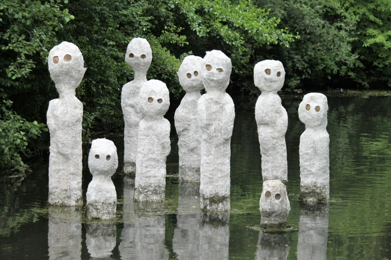 a number of statues that are in a body of water