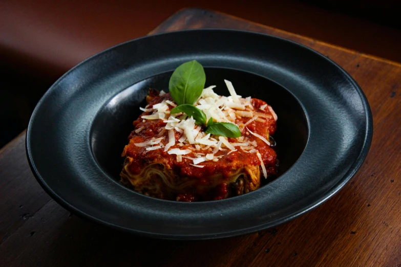 a dish of lasagna and grated parmesan