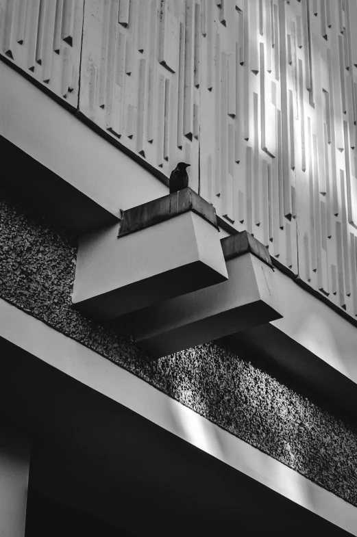 black and white po of an unusual object hanging over the top of a building