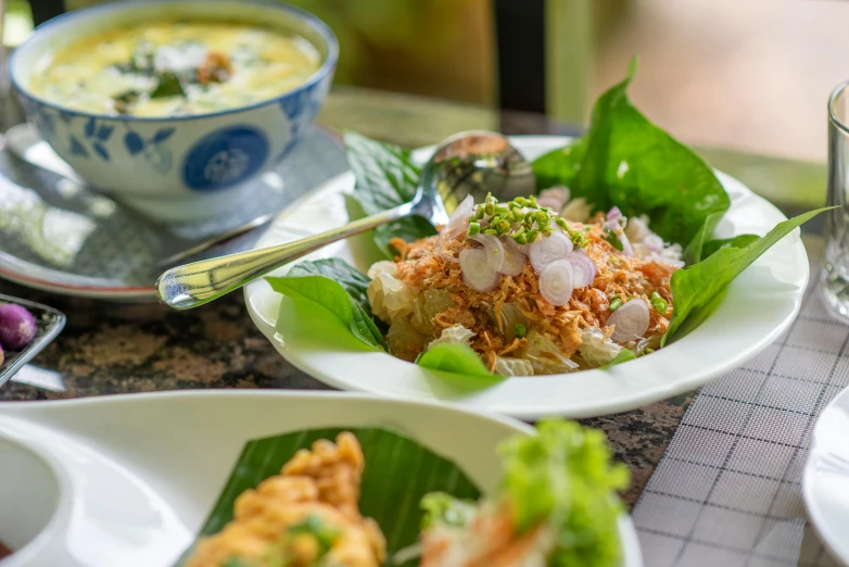 bowls filled with food sit on top of plates