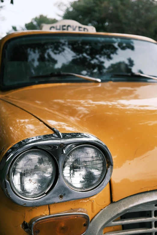 an old taxi cab parked by the curb