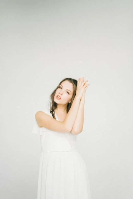 a young woman in white with her arms out