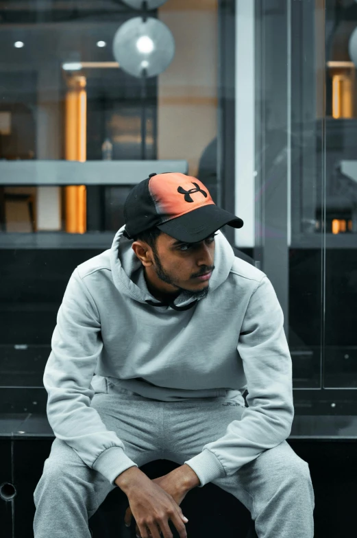 a young man sitting down looking at his cell phone