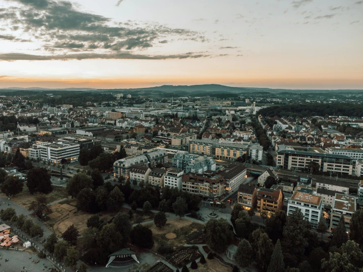 the cityscape of the town is lit up at dusk